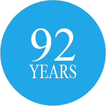blue-92-years-icon Blue circular icon with 92 years in the middle in white lettering